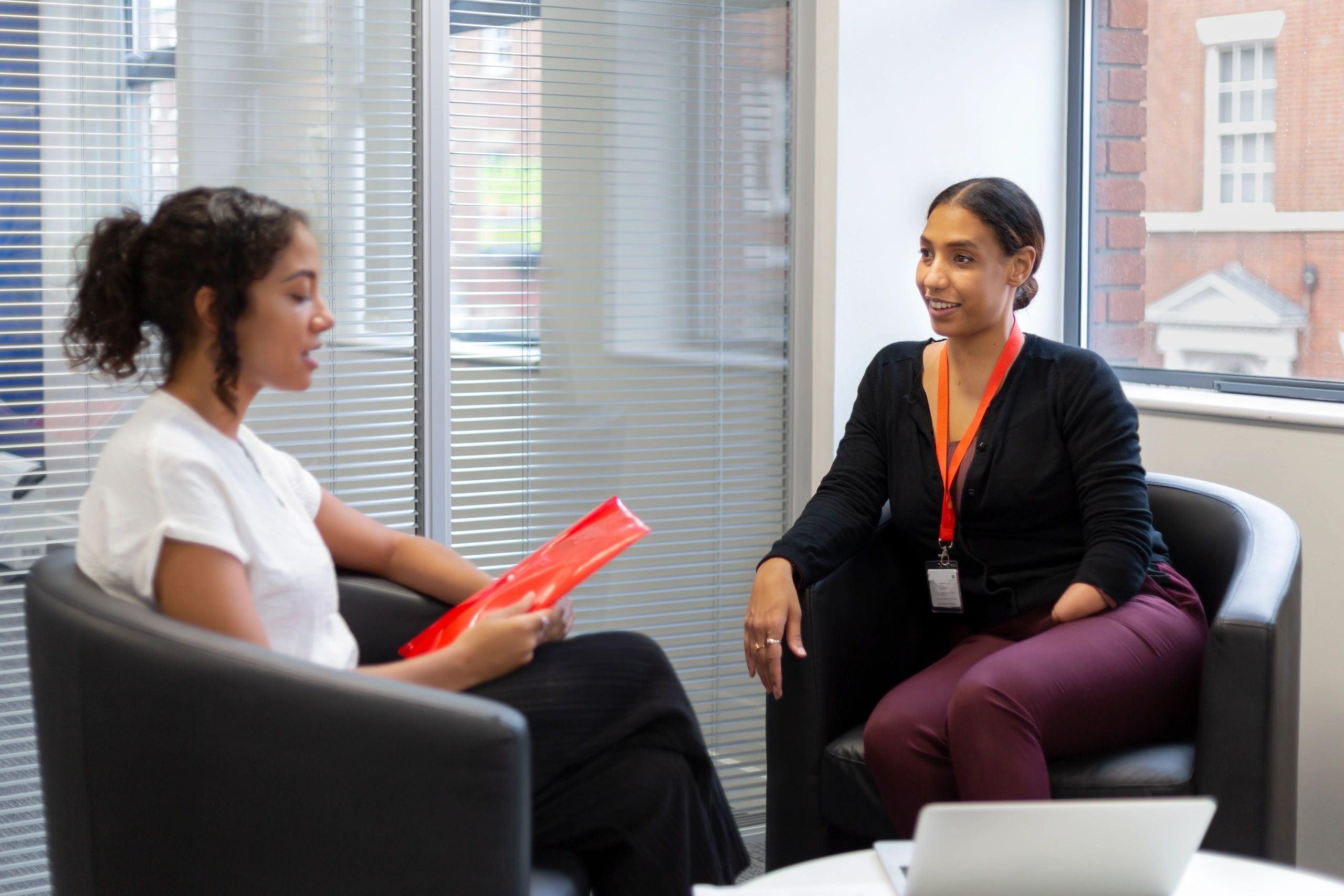 Two colleagues in an office conversation