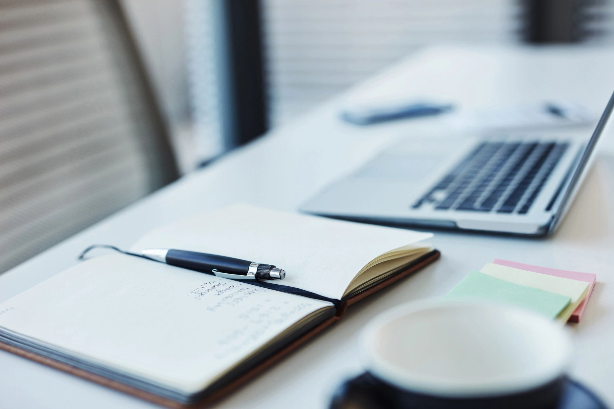 Notebook and laptop on a desk
