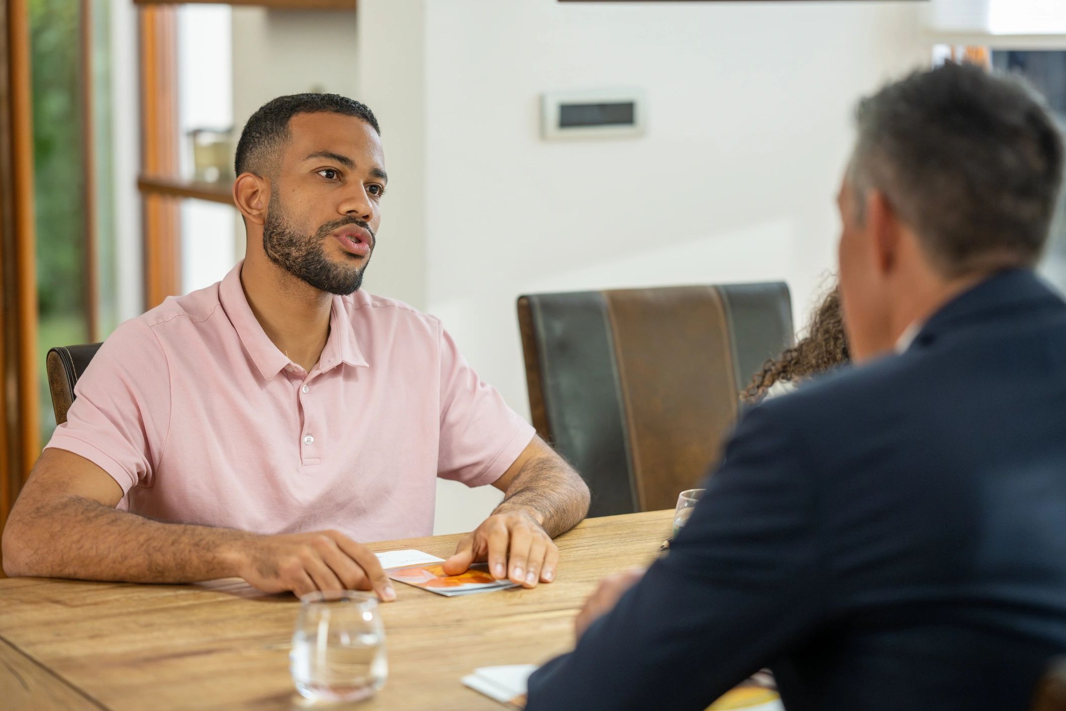 Two professionals discussing an agreement in an office setting