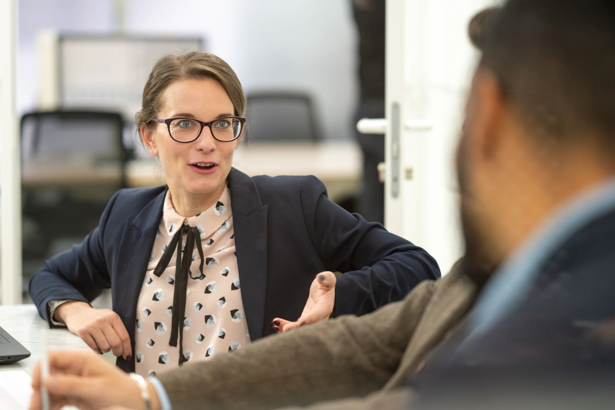 Colleagues talking during an office meeting