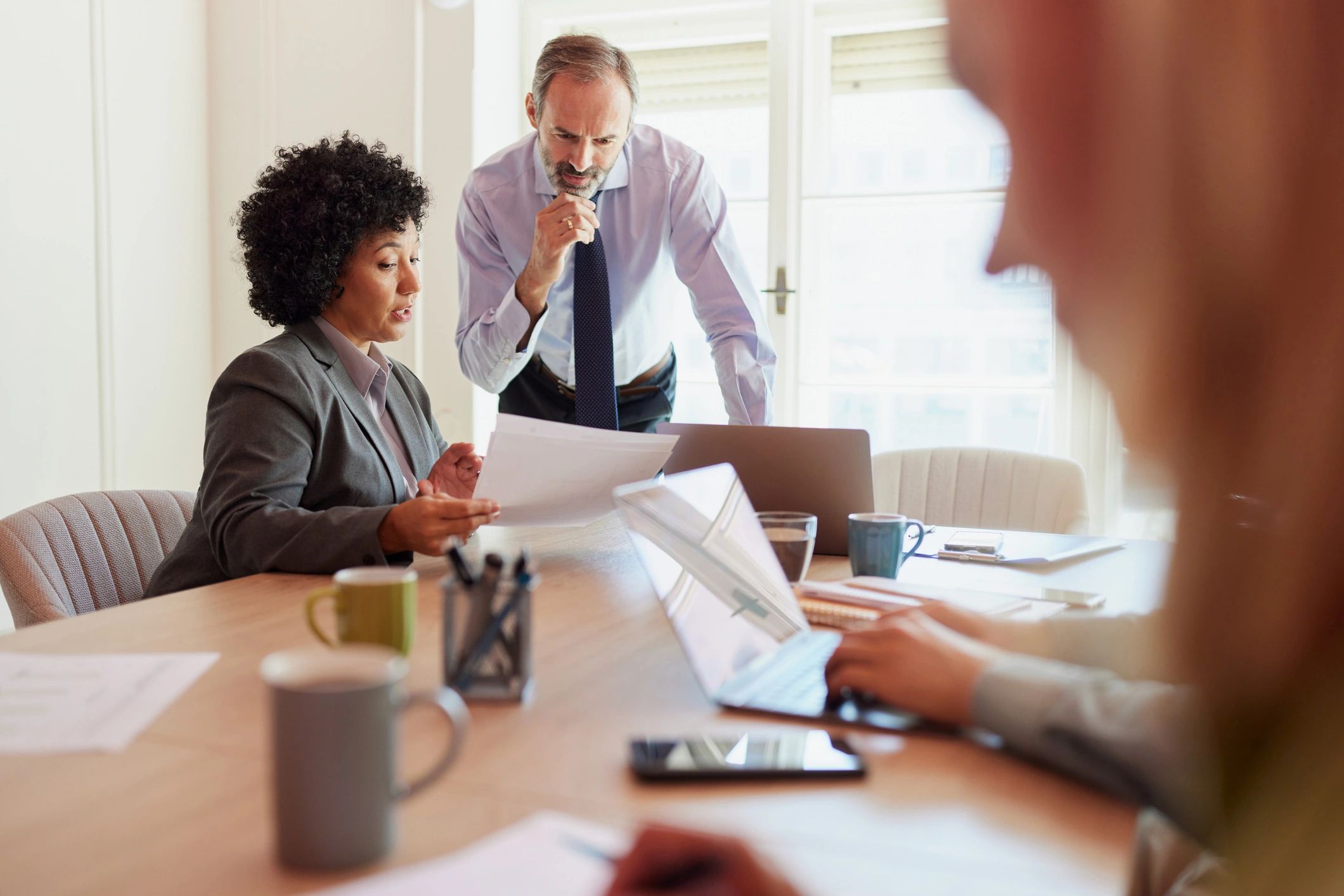 Entrepreneur reviewing reports with a colleague in an office meeting