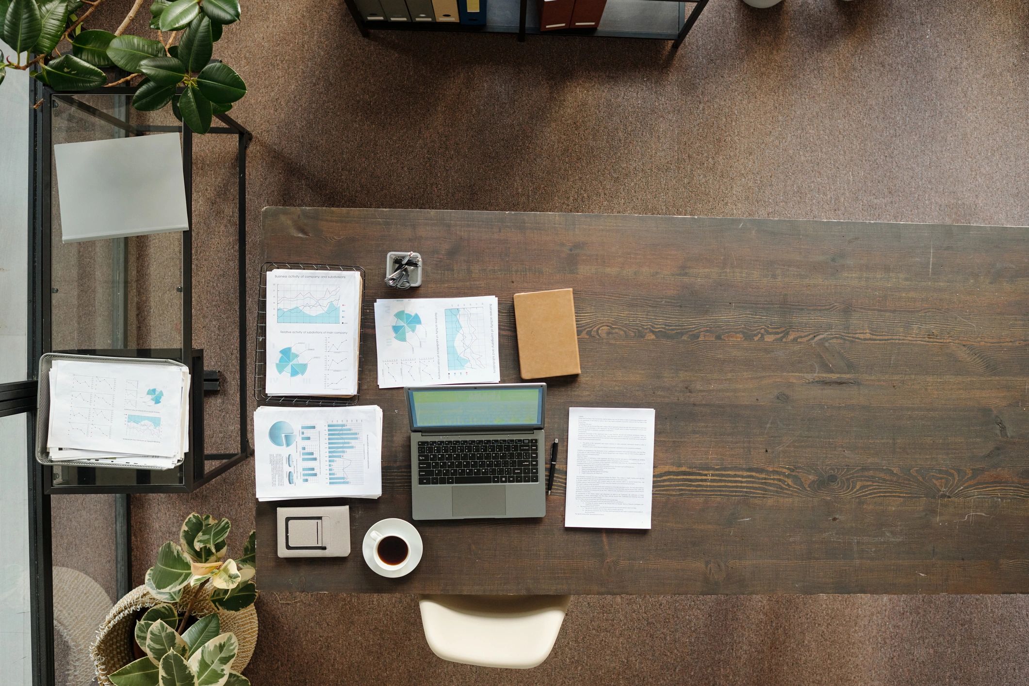 Laptop with business documents and coffee on a desk
