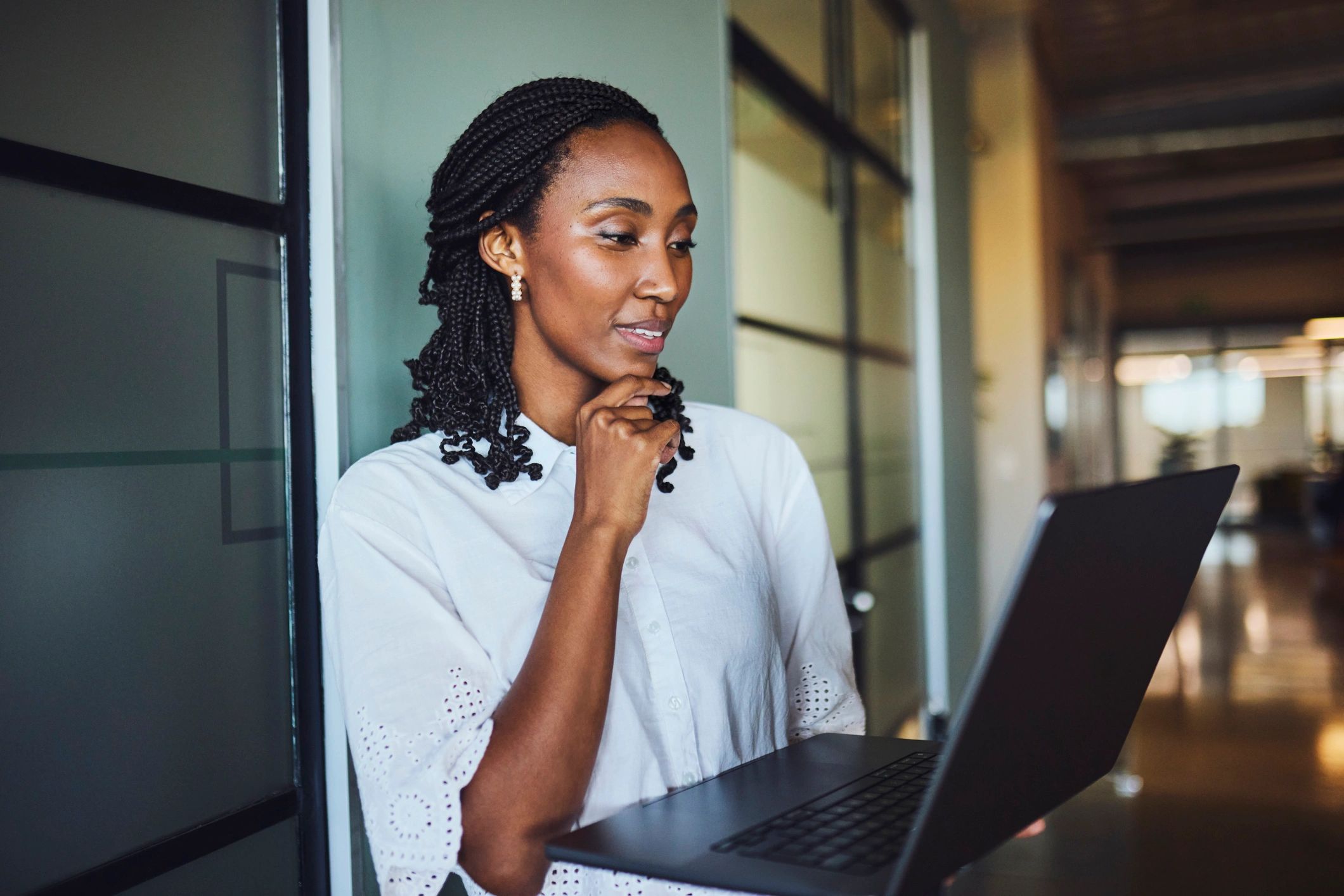 Consultant working on a laptop in a modern office
