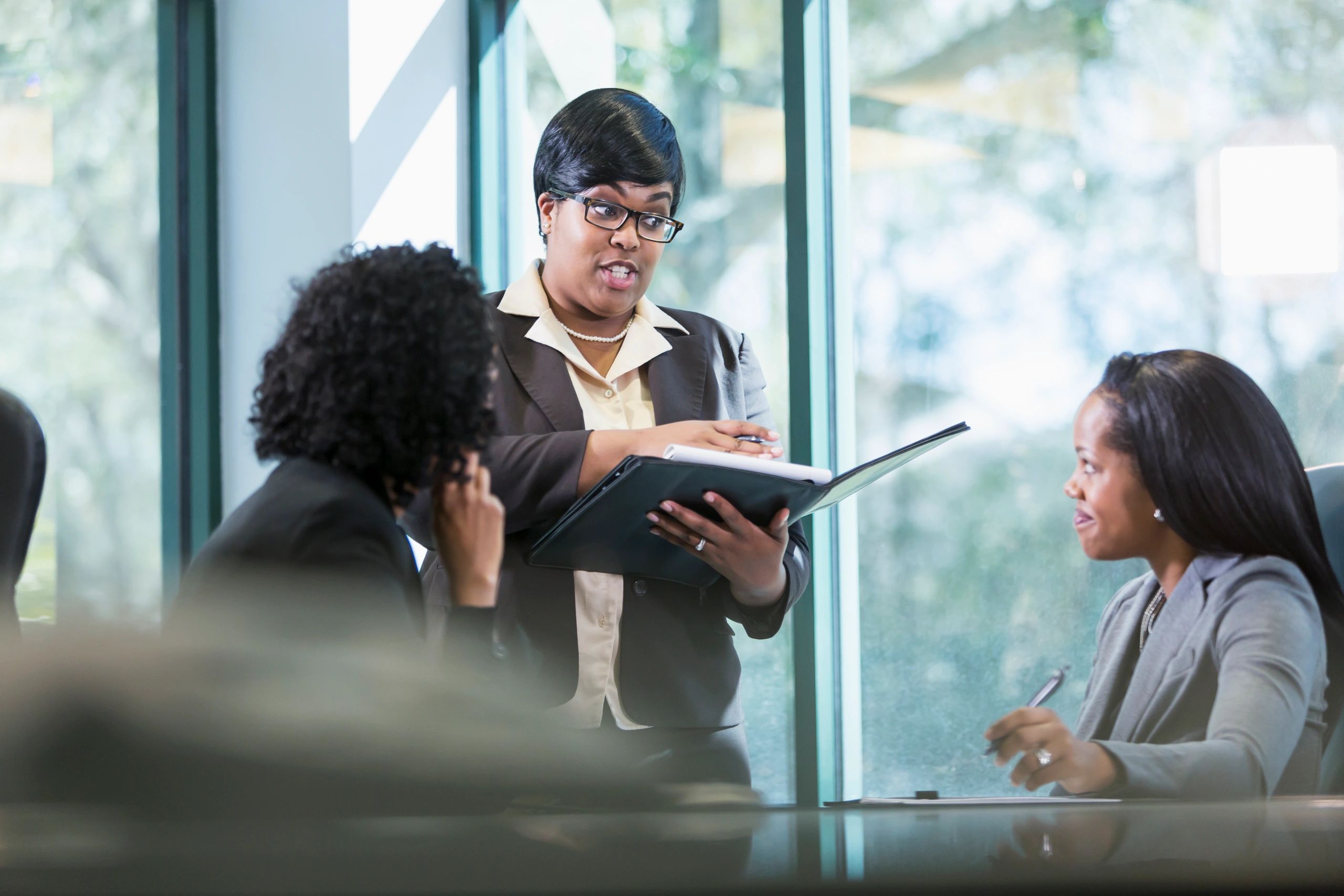 Businesswoman presenting to colleagues in a conference room
